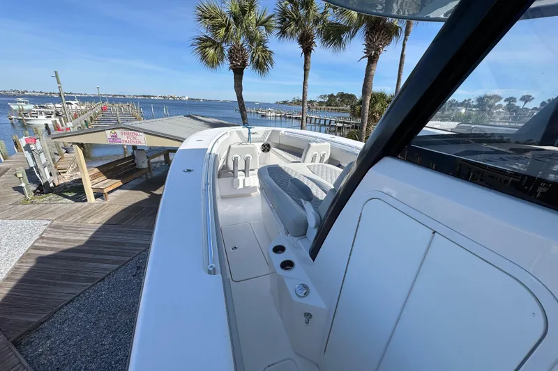 Slide: The Image of 2021 Invincible 36 Open Fisherman boat docked near palm trees and marina. - 9