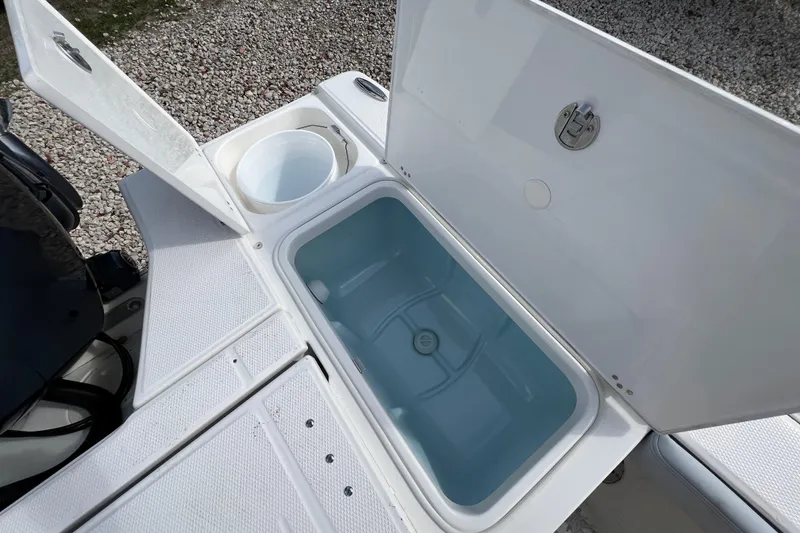 Slide: The Image of Livewell and storage compartments on 2026 Robalo 226 Cayman boat. - 10