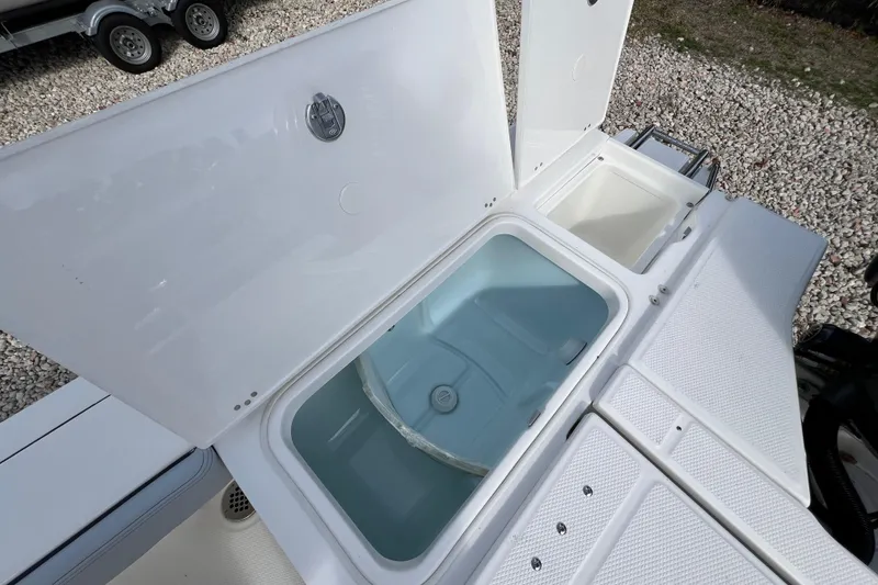 Slide: The Image of 2026 Robalo 226 Cayman boat with open storage compartments on deck. - 11