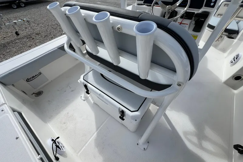 Slide: The Image of 2026 Robalo 226 Cayman boat interior with rod holders and seating. - 13