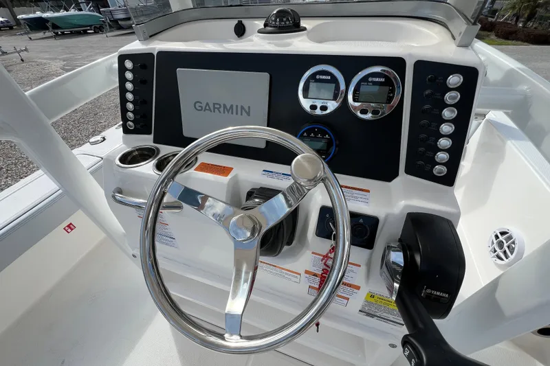 Slide: The Image of 2026 Robalo 226 Cayman boat dashboard with Garmin navigation and Yamaha controls. - 14