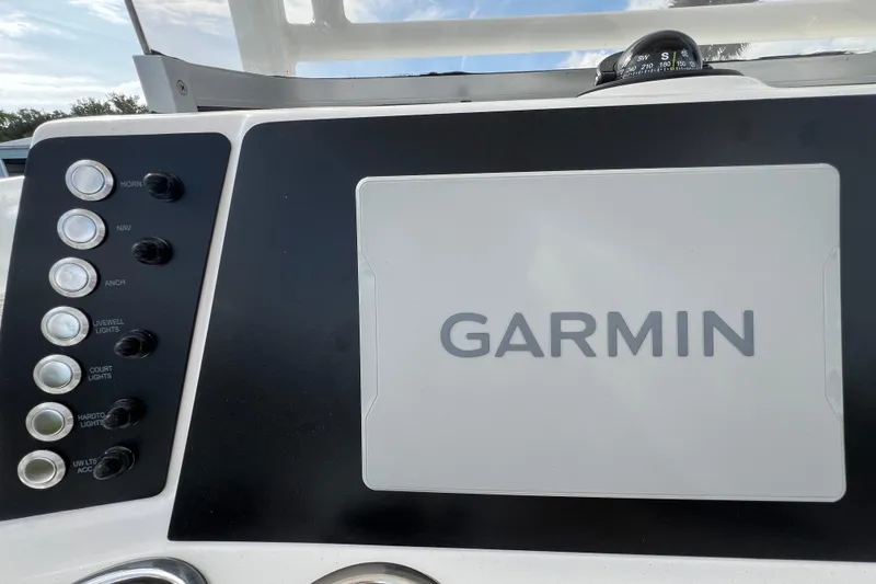 Slide: The Image of Garmin navigation system on 2026 Robalo 226 Cayman boat dashboard with control switches. - 17