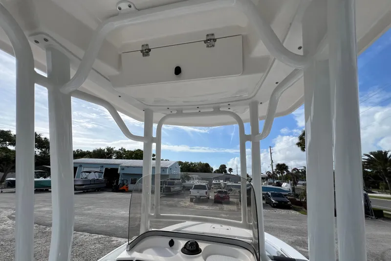 Slide: The Image of 2026 Robalo 226 Cayman boat interior with T-top and storage compartment. - 18