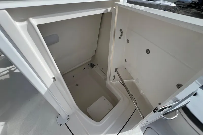 Slide: The Image of Open storage compartment on 2026 Robalo 226 Cayman boat, showcasing spacious interior design. - 20