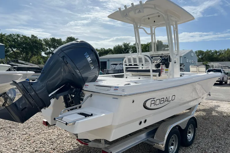 Slide: The Image of 2026 Robalo 226 Cayman boat with Yamaha engine on trailer, outdoors. - 4