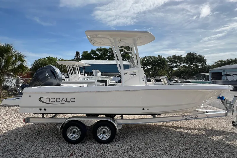 Slide: The Image of 2026 Robalo 226 Cayman boat on trailer, outdoor setting, clear sky. - 5