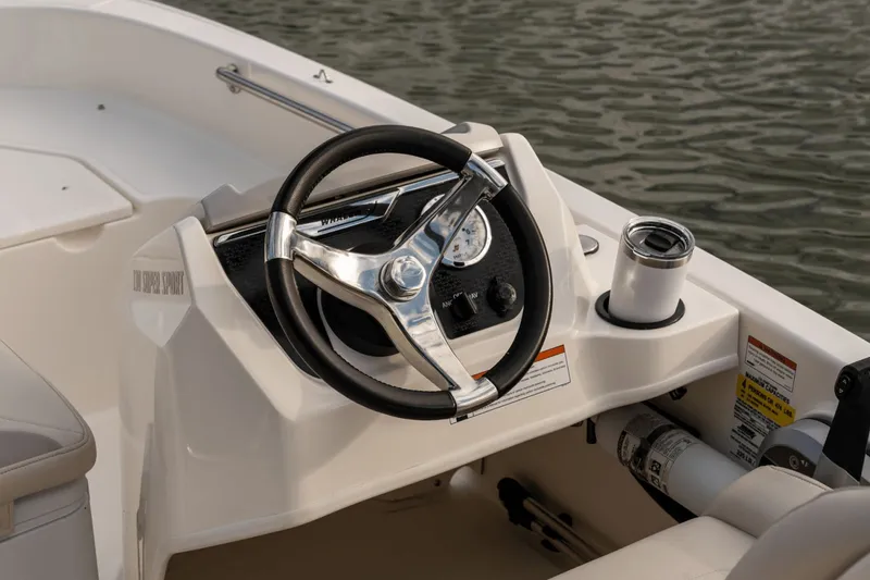 Slide: The Image of The image shows the helm of a 2026 Boston Whaler 130 Super Sport. - 39