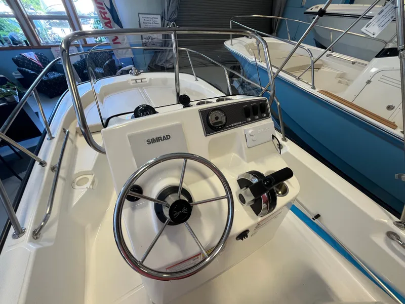 Slide: The Image of The image shows the cockpit of a Boston Whaler 150 Montauk with a Simrad control system. - 6