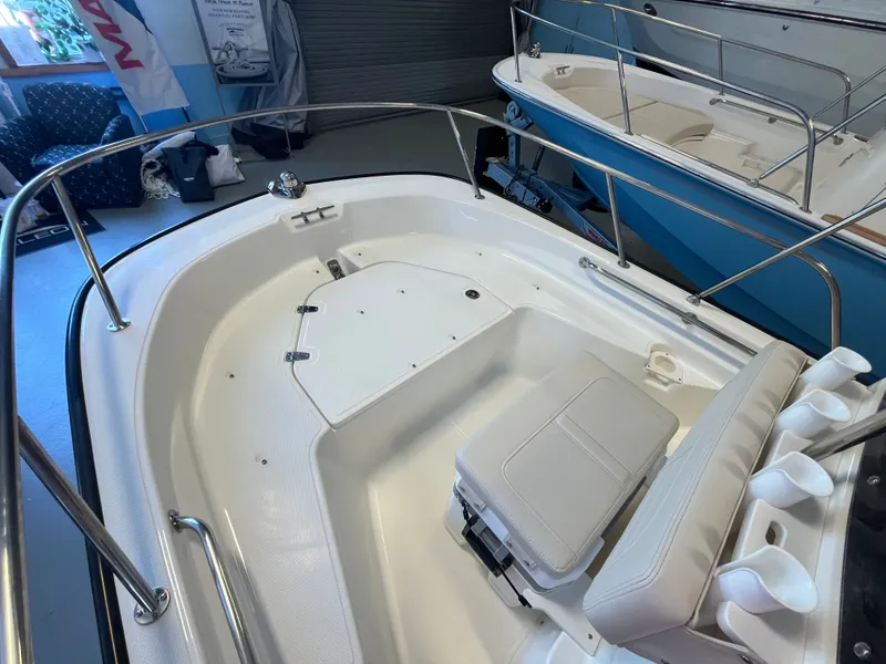Slide: The Image of The image shows the cockpit of a Boston Whaler 150 Montauk with white seating and stainless steel railing. - 8