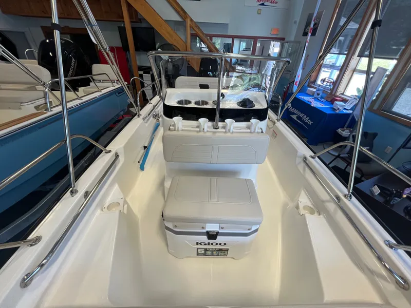 Slide: The Image of Interior view of a Boston Whaler 150 Montauk with seating and a helm console. - 10