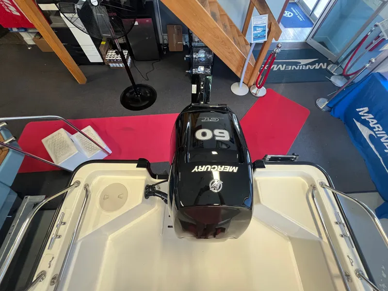 Slide: The Image of Interior view of a Boston Whaler 150 Montauk with a Mercury 60 HP engine. - 1