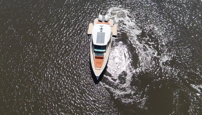 Slide: The Image of Aerial view of a 2027 Saxdor 320 GTO on water, with clear wave patterns. - 29