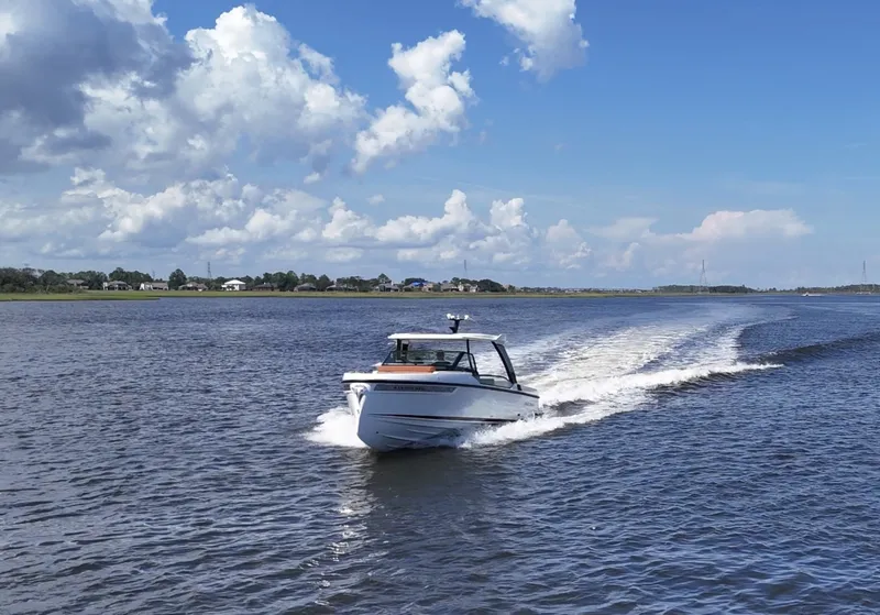 Slide: The Image of A 2027 Saxdor 320 GTO cruising on calm waters under a blue sky. - 40