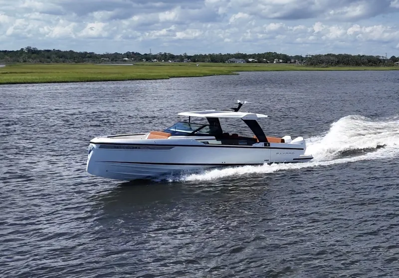 Slide: The Image of Saxdor 320 GTO 2027 on the water, modern design, white hull, open cabin, cruising swiftly. - 39