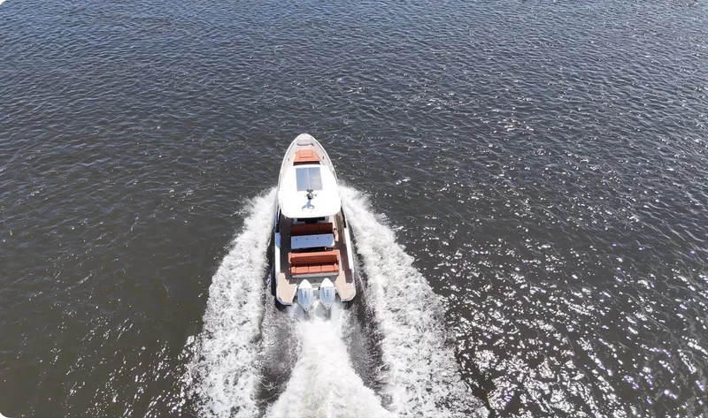 Slide: The Image of Saxdor 320 GTO from 2027 speeding across the water, leaving a trail of wake. - 41