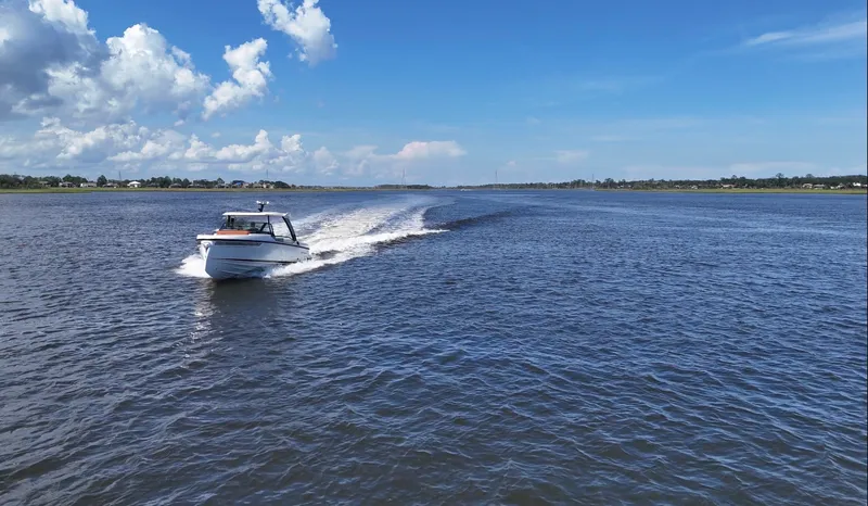 Slide: The Image of A 2027 Saxdor 320 GTO speeds across the water under a clear blue sky. - 42