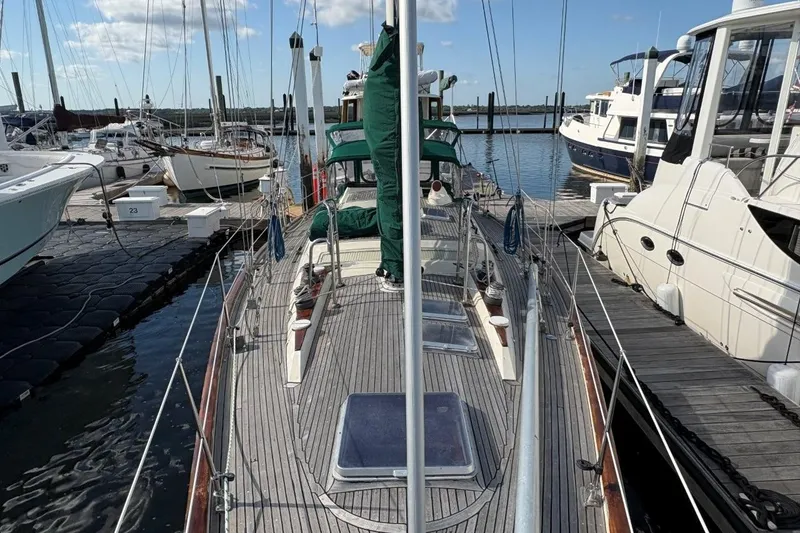 Slide: The Image of Sailboat docked at marina, Norseman 447, 1981 model, surrounded by other boats. - 10