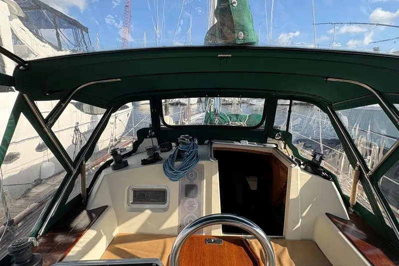 Slide: The Image of Cockpit view of a 1981 Norseman 447 sailboat with green canopy and nautical equipment. - 14