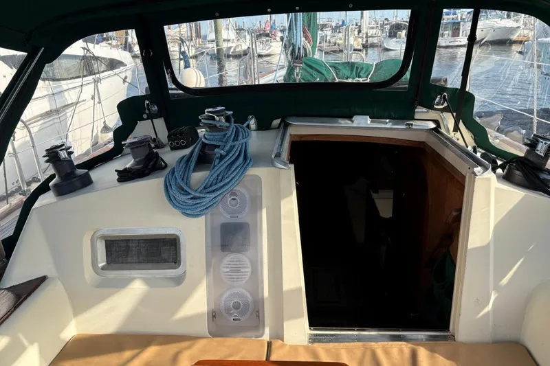 Slide: The Image of Cockpit of 1981 Norseman 447 sailboat with ropes and winches, docked at marina. - 17