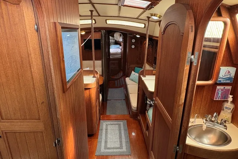Slide: The Image of Interior of a 1981 Norseman 447 yacht, featuring wooden cabinetry and cozy living space. - 19