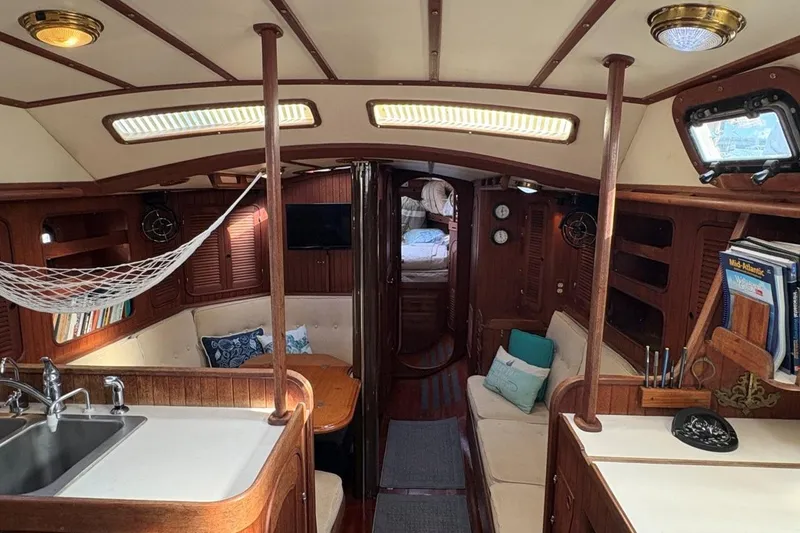 Slide: The Image of Interior of 1981 Norseman 447 yacht with cozy seating, kitchen, and wooden accents. - 20