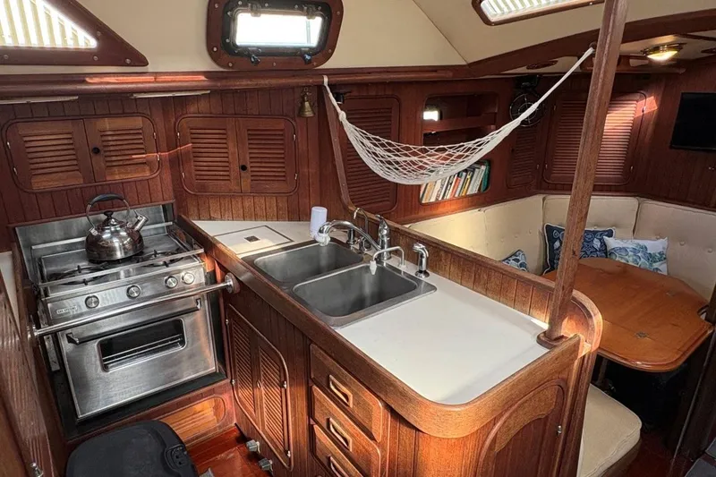 Slide: The Image of Interior of 1981 Norseman 447 yacht with kitchen, sink, stove, and cozy seating area. - 21