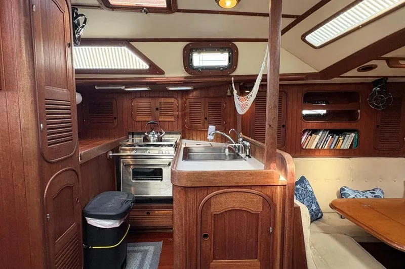 Slide: The Image of Interior of 1981 Norseman 447 yacht with wooden cabinetry and compact kitchen area. - 23