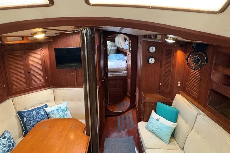 Slide: The Image of Interior of 1981 Norseman 447 yacht with cozy seating and wooden finishes. - 25