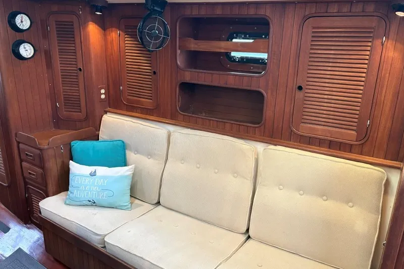 Slide: The Image of Interior of 1981 Norseman 447 yacht with wooden paneling and cushioned seating. - 27