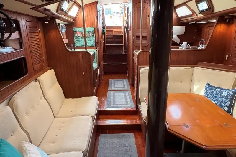 Slide: The Image of Interior of 1981 Norseman 447 yacht with wooden furnishings and cozy seating area. - 28