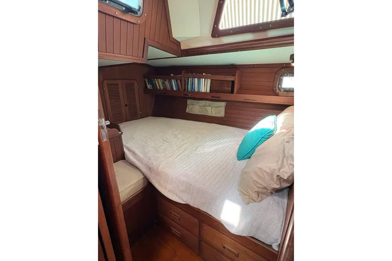 Slide: The Image of Cozy cabin interior of 1981 Norseman 447 sailboat with wooden finish and bookshelf. - 33
