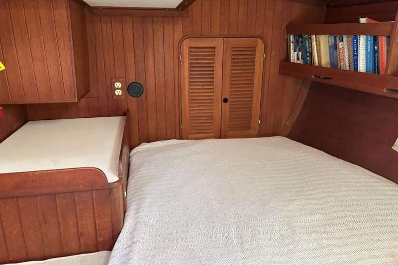Slide: The Image of Cozy 1981 Norseman 447 yacht cabin with wood paneling and bookshelf. - 35