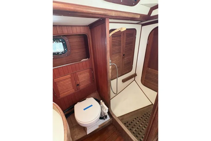 Slide: The Image of 1981 Norseman 447 yacht bathroom with wooden interior and shower area. - 37