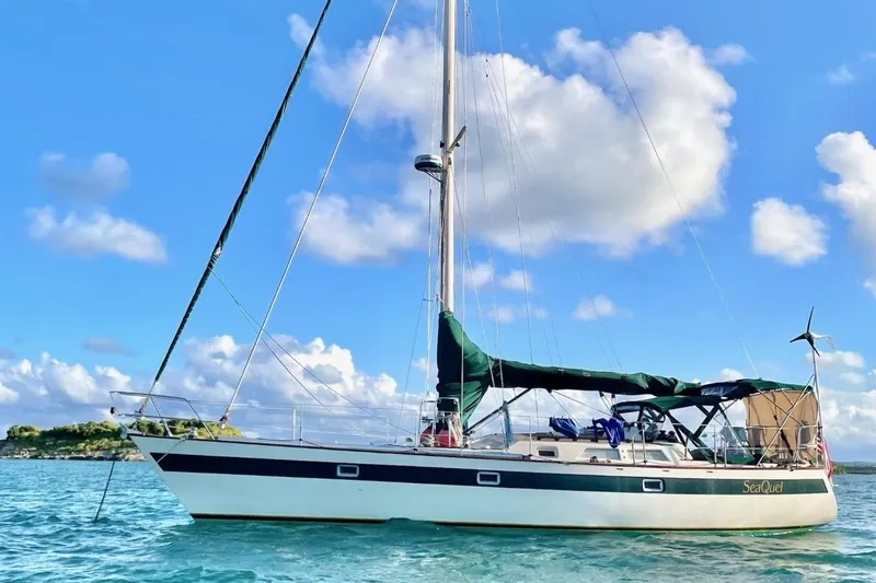 Slide: The Image of Sailboat Norseman 447, 1981 model, anchored in clear blue waters under a sunny sky. - 42