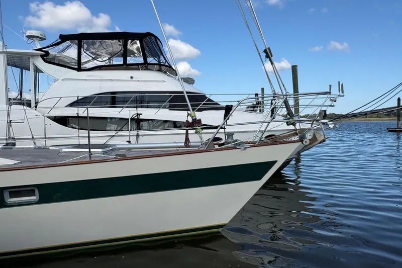 Slide: The Image of 1981 Norseman 447 yacht docked in a marina, clear sky, calm water. - 5