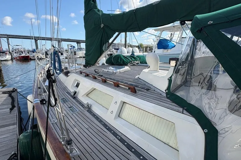 Slide: The Image of Sailboat docked at marina, Norseman 447, 1981 model, with green canvas cover. - 6