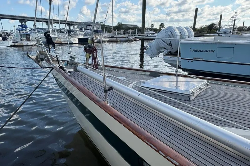 Slide: The Image of Sailboat docked in marina, Norseman 447, 1981 model, with clear sky and water reflections. - 8