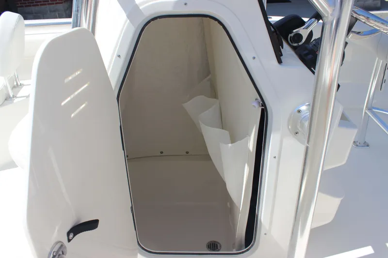 Slide: The Image of 2026 Key West 203 FS boat interior storage compartment with open door. - 10