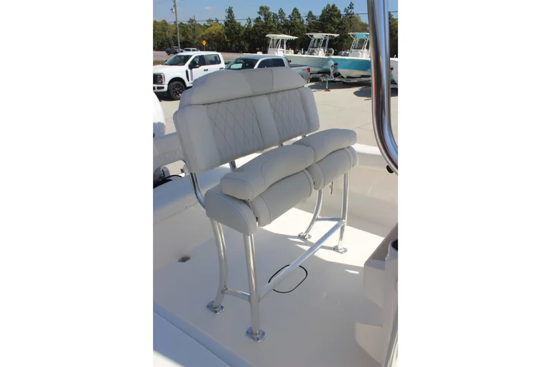 Slide: The Image of 2026 Key West 203 FS boat with white cushioned seating and stainless steel frame. - 13