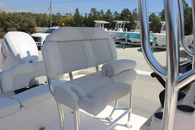 Slide: The Image of 2026 Key West 203 FS boat interior with white cushioned seating and stainless steel details. - 14