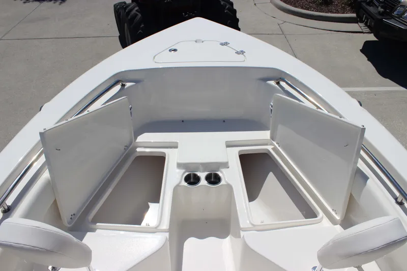Slide: The Image of Bow seating area of 2026 Key West 203 FS boat with storage compartments open. - 18