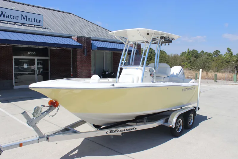 Slide: The Image of 2026 Key West 203 FS boat on trailer outside marine dealership. - 2