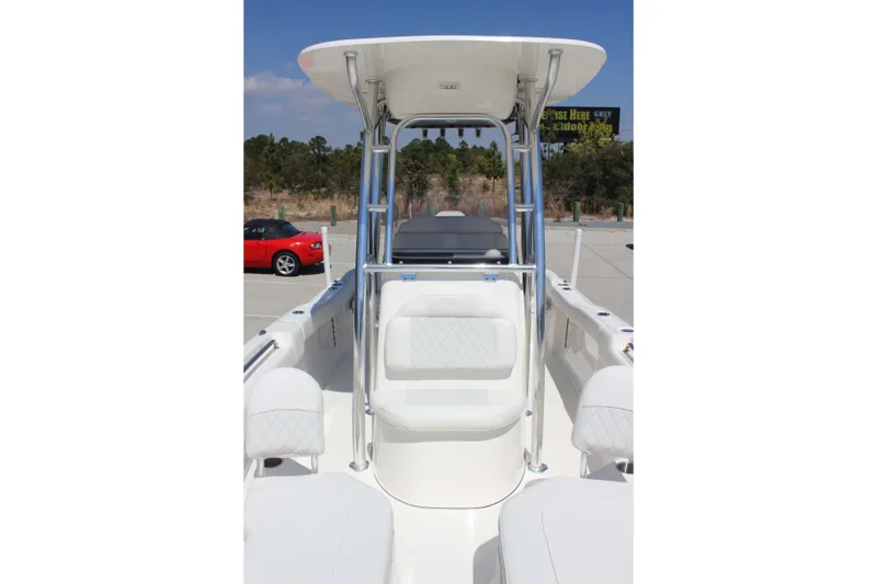 Slide: The Image of 2026 Key West 203 FS boat interior with seating and T-top in a parking lot. - 20