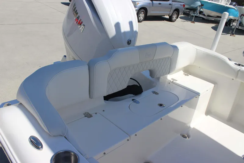Slide: The Image of 2026 Key West 203 FS boat interior with Yamaha engine, featuring white cushioned seating. - 23