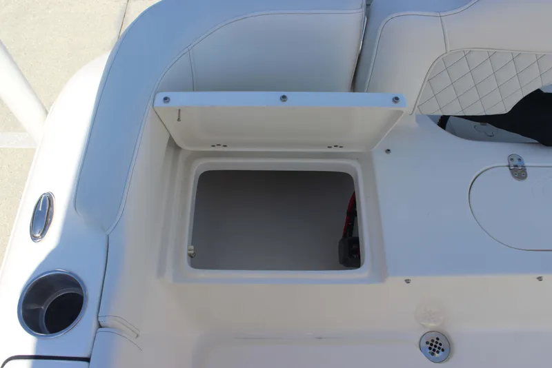 Slide: The Image of Open storage compartment on 2026 Key West 203 FS boat, featuring white cushioned seating. - 24