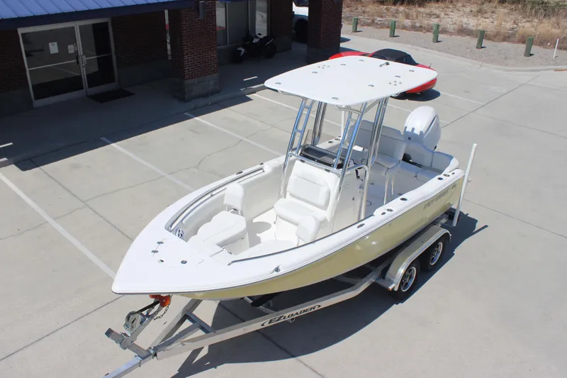 Slide: The Image of 2026 Key West 203 FS boat on trailer in parking lot, featuring sleek design and modern amenities. - 27
