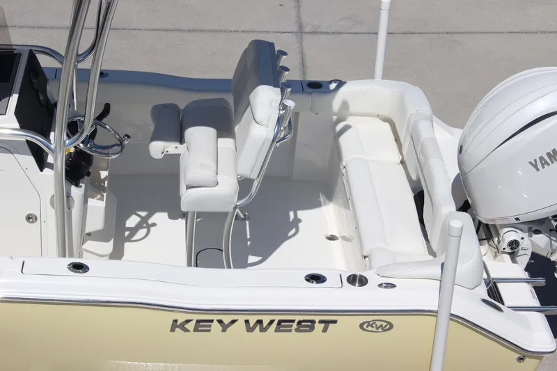 Slide: The Image of 2026 Key West 203 FS boat interior with Yamaha engine, featuring white seating and steering console. - 30