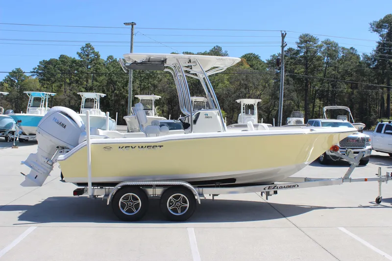 Slide: The Image of 2026 Key West 203 FS boat on trailer, parked outdoors, side view. - 4