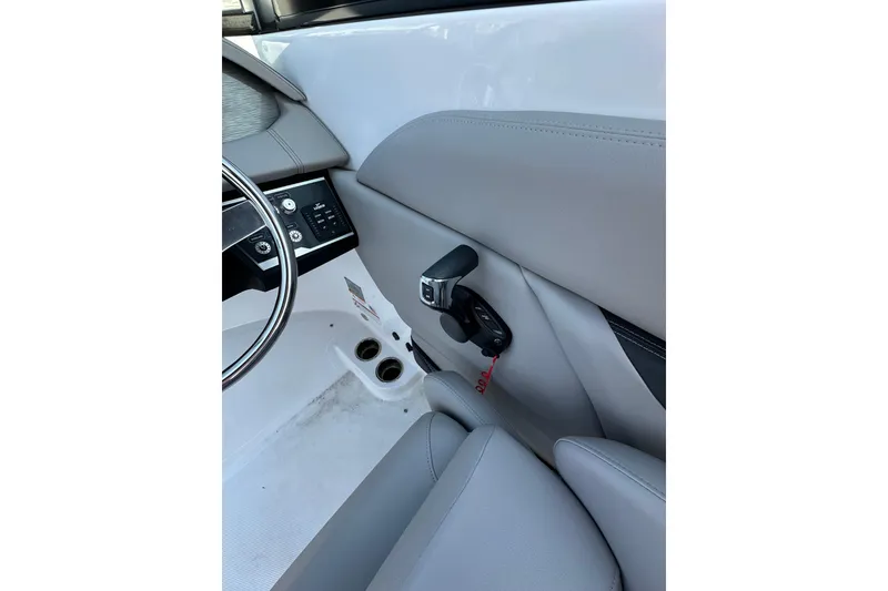 Slide: The Image of 2022 Four Winns HD8 OB boat interior, featuring steering wheel and control panel. - 10