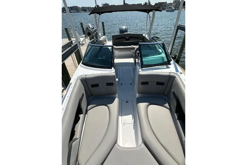 Slide: The Image of 2022 Four Winns HD8 OB boat with spacious seating, docked by the water. - 14
